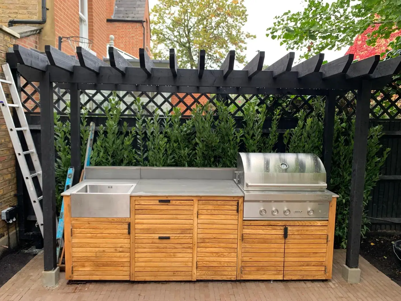 Outdoor kitchen under a pergola; photograph 54